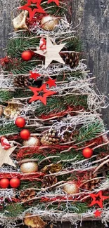 Rustic Christmas tree with festive decorations on a wooden background.