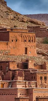 Clay village architecture with rocky background.