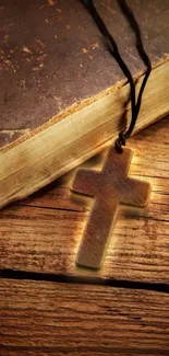 Wooden cross on a rustic book background.