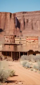 Rustic Wild West saloon in desert landscape with canyon backdrop.