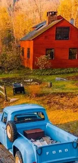 Vintage blue truck beside a rustic red farmhouse.