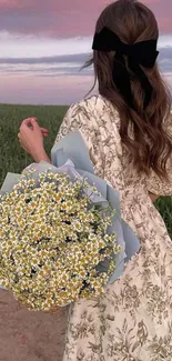 Woman in floral dress with sunset and flowers.