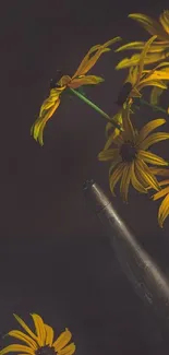 Rustic yellow daisies in a metal watering can with a dark background.