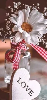 Rustic vase with daisy and heart on a text background.