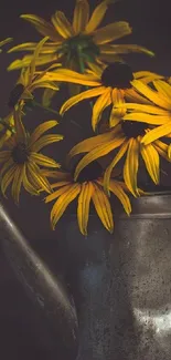 Yellow flowers in metal can against dark background.