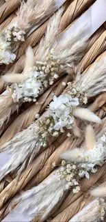 Rustic floral wallpaper with pampas and flowers on woven background.