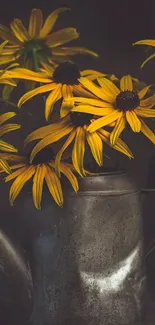 Yellow flowers in a rustic metal vase with a dark background.