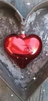 Rustic metal heart with red heart accent on wood surface.