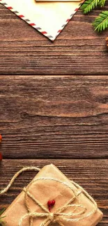 Rustic holiday wallpaper with gift and pine cones on wood.