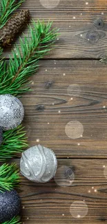 Festive phone wallpaper with Christmas pine and ornaments on wooden background.