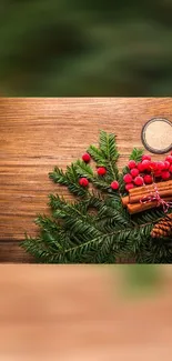 Rustic holiday wallpaper with green fir and red berries on wooden background.