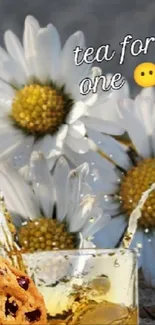 Rustic key with wild daisies and whiskey glass on wooden surface.