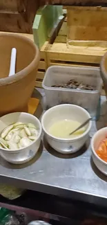 Rustic kitchen setup with bowls and ingredients on a table.