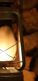 Antique lantern glowing warmly against stacked firewood backdrop.