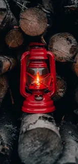 Red lantern glowing on stacked wooden logs.