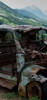 Rusty truck with mountain backdrop scenery.