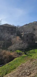 Serene rustic stone houses in mountain village under a blue sky.