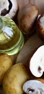 Overhead view of mushrooms, olive oil, and potatoes on a rustic wooden surface.