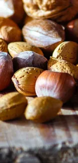 Close-up of assorted nuts on wooden surface wallpaper.