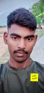 Outdoor rural selfie with olive green shirt.