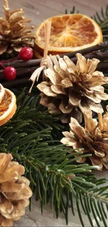 Rustic holiday wallpaper with pinecones, dry oranges, and evergreen leaves.