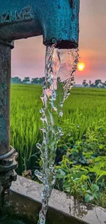 A scenic view of a water pump with a sunset.