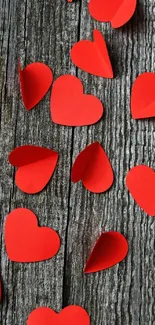 Red paper hearts on rustic wooden planks wallpaper.