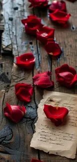 Red rose petals on rustic wooden background with vintage letter.