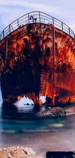 Rustic shipwreck on a calm ocean backdrop, showcasing dramatic colors.