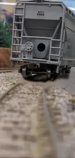 Close-up of a train car on tracks in a rustic setting.