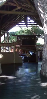 Rustic treehouse with wooden pathway and greenery.