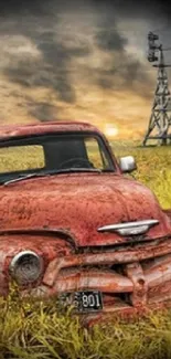 Vintage truck in a golden field under a dramatic sky at sunset.