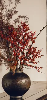 Rustic vase with red berries on table.