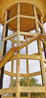 Rustic water tower against a cloudy sky.