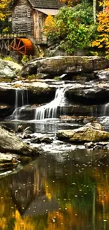 Rustic watermill with autumn foliage and waterfalls in a peaceful scene.