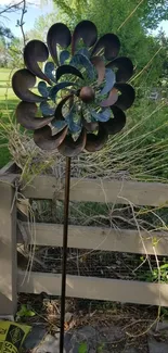 Rustic windmill in a serene garden setting.