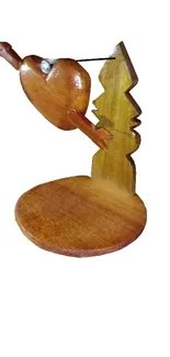 Rustic wooden bird sculpture on a stand.