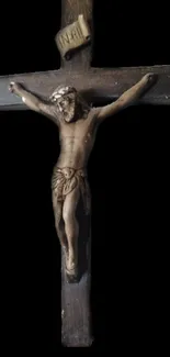 Wooden crucifix on a dark background wallpaper.