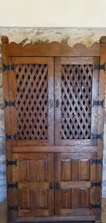 Rustic wooden cabinet against stone wall background.