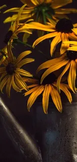 Yellow flowers in a metal watering can on dark background.