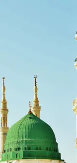 Majestic mosque domes under a clear blue sky.