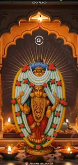 Hindu deity adorned with flowers and candles in a peaceful setting.