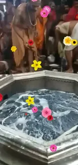 Hindu ritual with floating flowers and dark water.