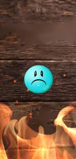 Sad blue emoji on fiery wooden background with flames.