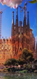 Mobile wallpaper of Sagrada Familia cathedral with blue sky and flowers.