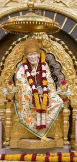 Sai Baba seated on a golden throne with colorful garlands.