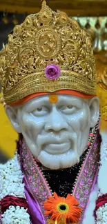 Sai Baba with golden crown and floral garlands.