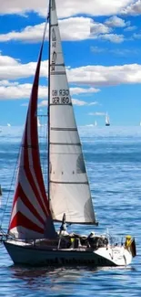 Sailboats on a bright blue sea under a clear sky.