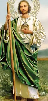 Saintly figure with green robe in serene landscape wallpaper.