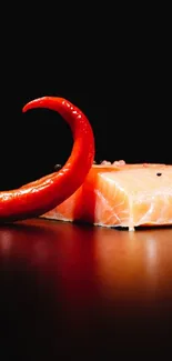 Close-up of fresh salmon and red chili on a black background.